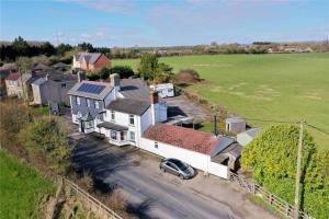 an aerial view of a house with a car at The Old Stable at Greatfield in Royal Wootton Bassett