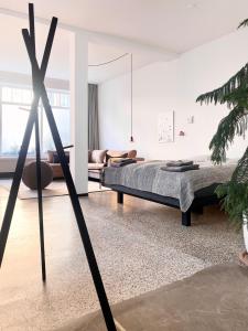 a bedroom with a bed and a living room at zehuus - historical charm 70qm in Cologne