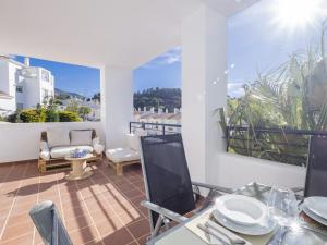 a room with a balcony with a table and chairs at Cubo's Apartment Alhaurin Golf & Parking in Alhaurín el Grande