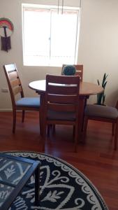 a dining room with a table and two chairs at Mini Casa en Viña del Mar in Viña del Mar