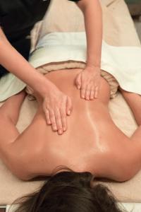 a woman laying on her back in a massage room at Vila Gale Collection Figueira da Foz in Figueira da Foz