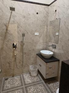 a bathroom with a sink and a shower at HERITAGE HAVELI VARANASI in Varanasi