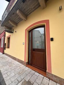 a building with a wooden door with a window at MANDANICI :Borgo Marsalini 2.0 in Barcellona-Pozzo di Gotto