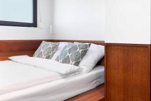 a bed with white sheets and pillows in a room at Good Spot Zieleniec Comfort Eco in Duszniki Zdrój