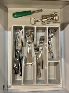 a tray with silver utensils in a drawer at Duke Vallehermoso Apartament in Madrid