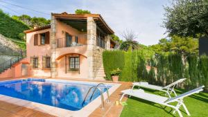 a villa with a swimming pool and a house at 1Esquer01 in Llafranc