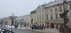a city street with buildings and people walking on the street at Old Town Apartment A in Warsaw