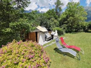 two chairs sitting in the grass in a yard at Glamping Narnia in Bovec