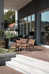 a patio with two chairs and a table on a house at Lamego Hotel & Life in Lamego