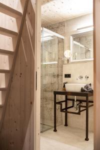 a bathroom with a sink and a glass shower at Kesslerstadel in Matrei in Osttirol