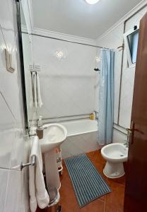a white bathroom with a sink and a toilet at Portuguese village apartment - Casa Martins No.54 in Freiria