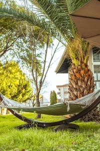 a hammock under a palm tree with a pineapple at BECANLAR OTEL in Yalova