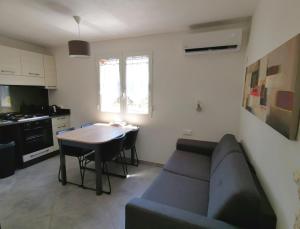 a living room with a couch and a table at Villa Giuseppina in Bonifacio