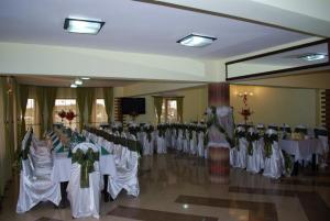 a room with a bunch of tables and gowns at Grandemi Belvedere Bucovina in Frasin