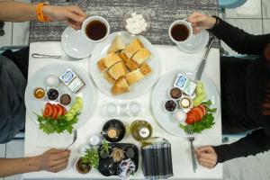 a table topped with plates of food and cups of coffee at BECANLAR OTEL in Yalova