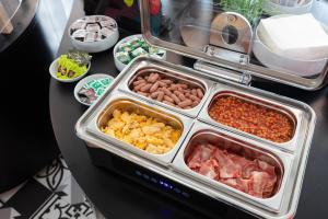 a buffet with many trays of different types of food at Stay Hotel Faro Centro in Faro