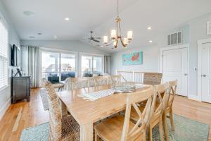 a dining room and living room with a table and chairs at Gorgeous Kure Beach Townhome - Walk to Ocean! in Kure Beach
