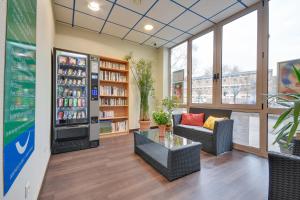 a store lobby with a couch and a drink cooler at Brit Hotel Lille Centre in Lille