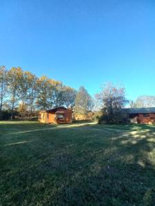 un gran campo de césped con una casa en el fondo en Cabañas De Madera, en La Unión