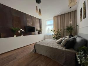 a bedroom with a bed and a flat screen tv at Sukiennicza Residence Old Town in Gdańsk