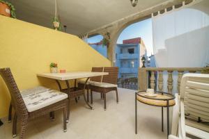 a balcony with a table and chairs on a balcony at Apartments Tomić in Vodice