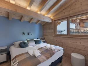 ein Schlafzimmer mit einem großen Bett in einem Holzzimmer in der Unterkunft 3 Fontaines - Apt C1 - BO Immobilier in Châtel