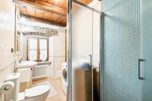 a bathroom with a shower and a toilet and a sink at Vivi Luxury Country House in Comano +81 photos
