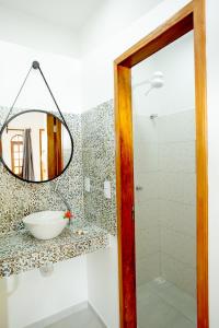 a bathroom with a mirror and a sink at Pousada Villa Caju in Jericoacoara +68 photos