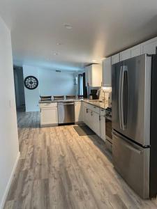a large kitchen with stainless steel appliances and wooden floors at Cozy Country Home Near Boyne City and Boyne Mt in Boyne City