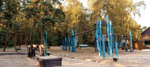 a park with a playground with a slide at Ferienhaus 8 Personen - b46443 
