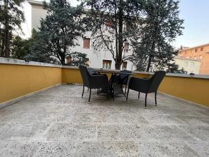 a table and chairs on top of a balcony at Garden suite / del ducato in Parma