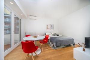 a bedroom with a bed and a table and chairs at Cozy & Bright Apartment - w/ Balcony in Udine