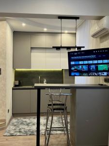 a kitchen with a desk with a computer on it at Apartments Superdom in Dnipro