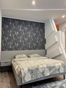 a bedroom with a large bed with a wall at Apartments Superdom in Dnipro