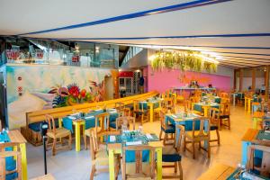a restaurant with blue and yellow tables and chairs at Impressive Punta Cana - All Inclusive in Punta Cana
