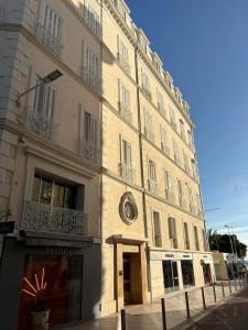 a large building with a clock on the side of it at Viva Riviera - Villa Royale in Cannes