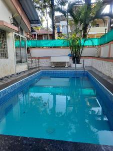 a pool in a house with blue water at Jhelum Villa by Sharayu Holidays in Panchgani