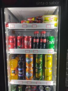 a refrigerator filled with different types of drinks at Pousada Luciana Dias in Palmas