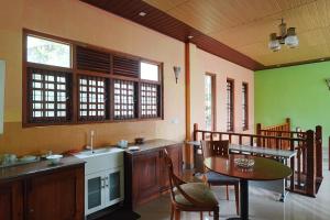 a kitchen with a table and a table and chairs at Suisse View Residence Kandy in Kandy
