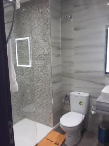 a bathroom with a toilet and a shower at Hôtel laluna bay in M'diq