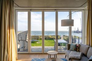 a living room with a view of the ocean at Strandhaus in Wyk auf Föhr