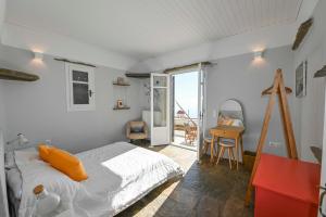 a bedroom with a bed and a desk and a window at Spectacular View in Istérnia
