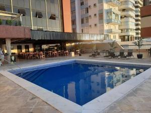 a swimming pool in front of a building at Flat no Sol Vitória Marina 2 in Salvador