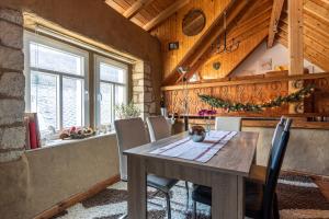 a dining room with a wooden table and chairs at Historisches Ferienhaus "Zur Linde" in Hausten