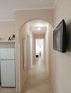 a living room with a television and a hallway at Apartment in Marina/Kampanien 21122 in Castellammare di Velia