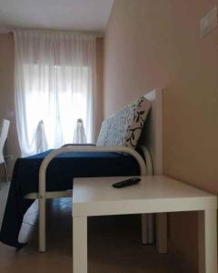a bedroom with a bed and a table and a window at Apartment Marina di Ascea 2 in Castellammare di Velia
