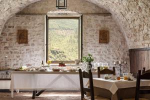 a dining room with a table and a window at Abbazia San Pietro In Valle in Ferentillo