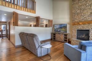 a living room with a couch and a fireplace at Tamarron Gambel Oak - 731 in Durango