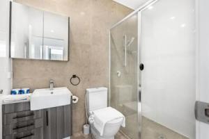 a bathroom with a toilet and a sink and a shower at Central of Toowong Neat Apt Near Station in Brisbane