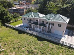 an aerial view of a white house with a green roof at Paradise nestled between Montego Bay and Negril in Hopewell